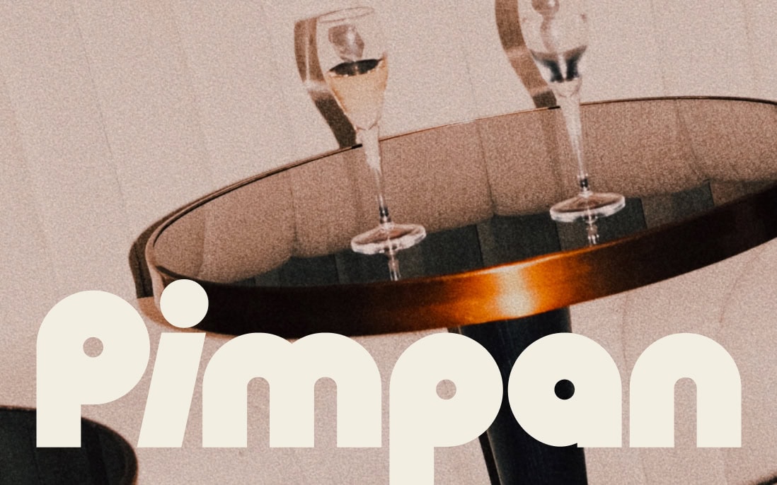A logotype design for Pimpan restaurant showed on top of a champagnes glasses photograph