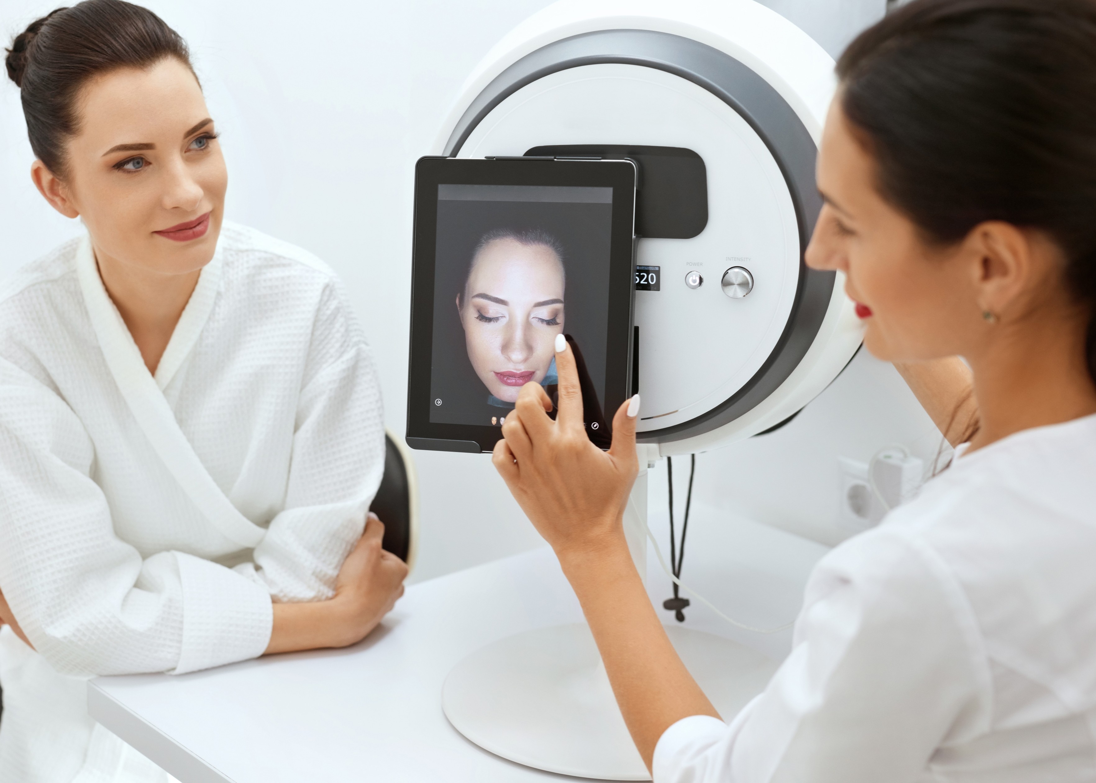 A woman using the Alma IQ device