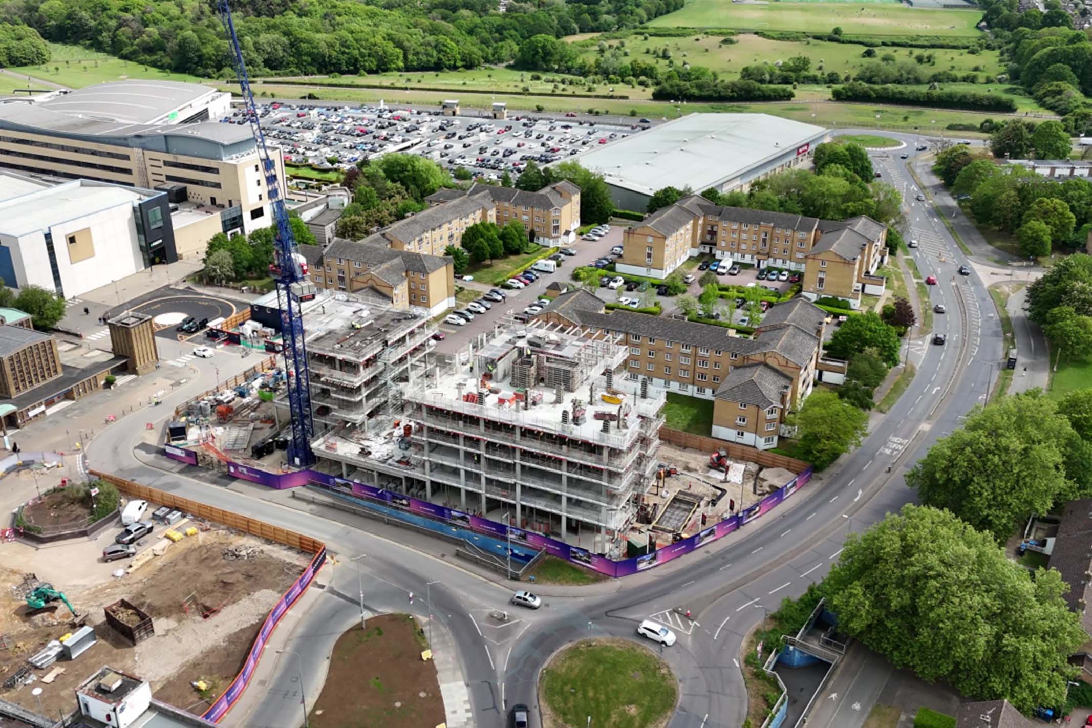 Aerial view of Harlow showing new residential development alongside existing housing and green spaces, illustrating regeneration and investment opportunities within the Essex property market.