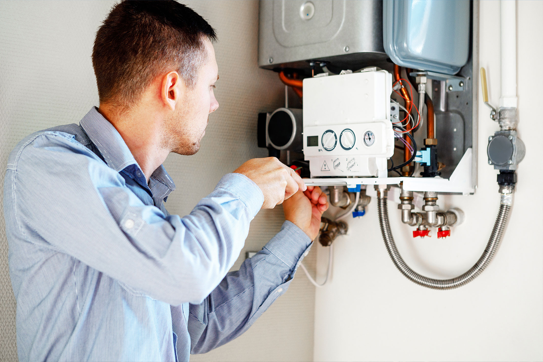Heating engineer working on a domestic boiler during a replacement or repair