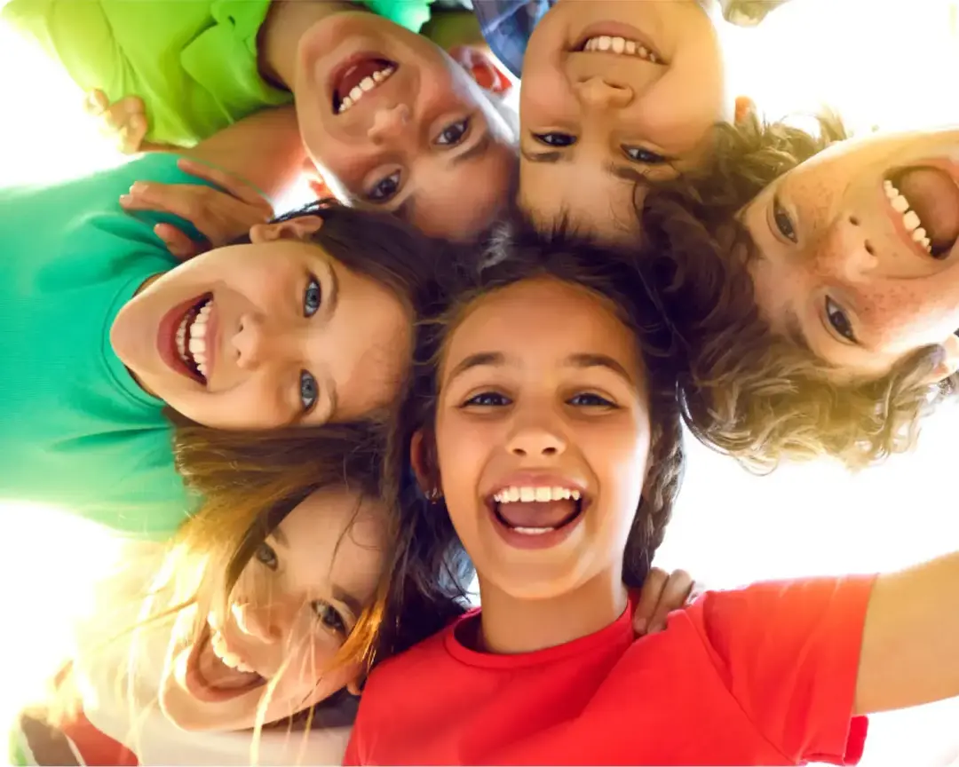 A group of children laughing in a circle