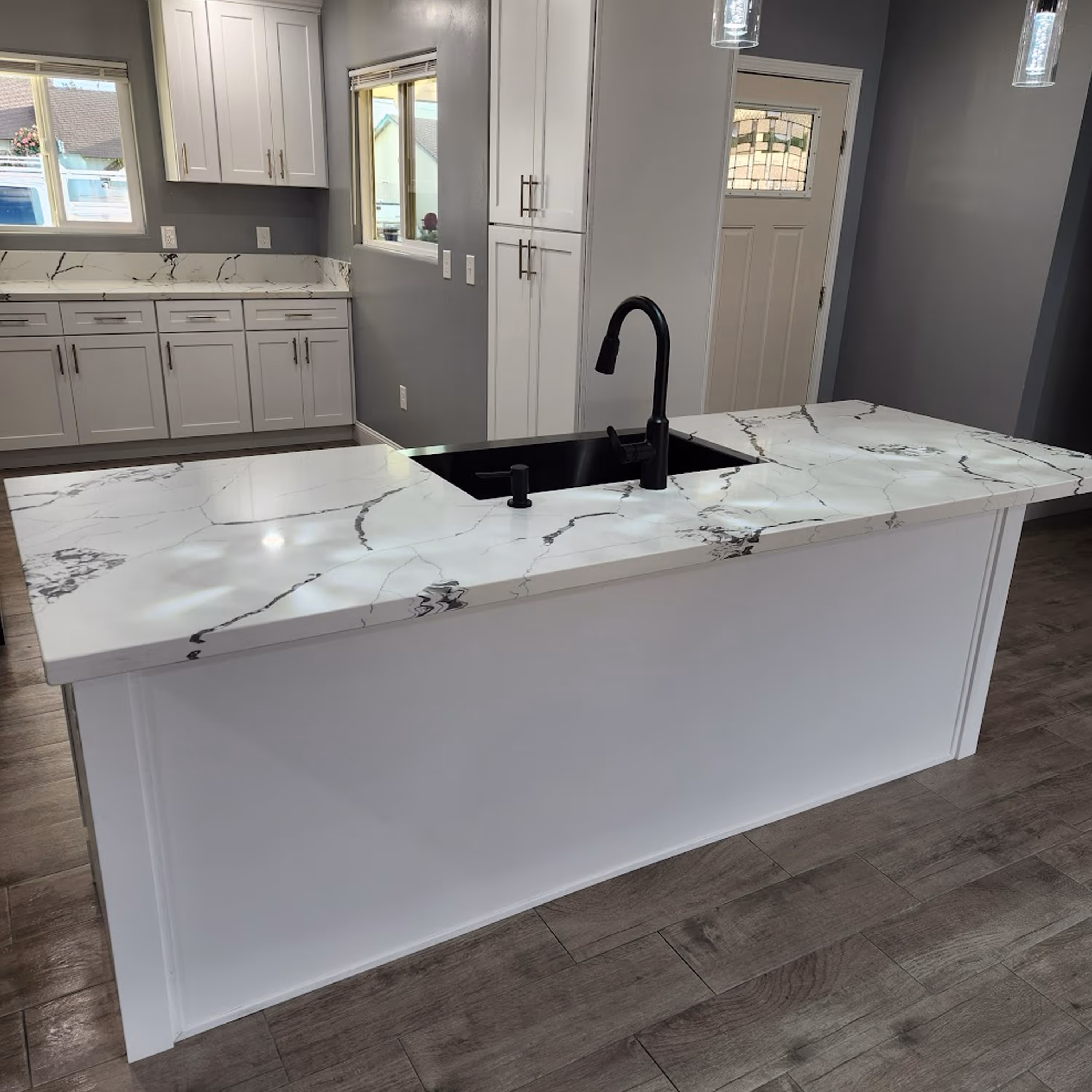 Open-concept kitchen renovation featuring custom island and updated lighting in Santa Maria, CA.