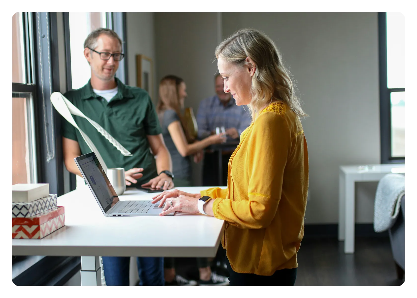 Colleagues reviewing digital information on a laptop in the office.