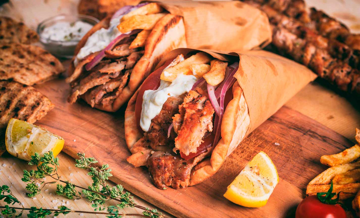  A vibrant display of Greek dishes, including moussaka and tzatziki, set against a bustling city backdrop.