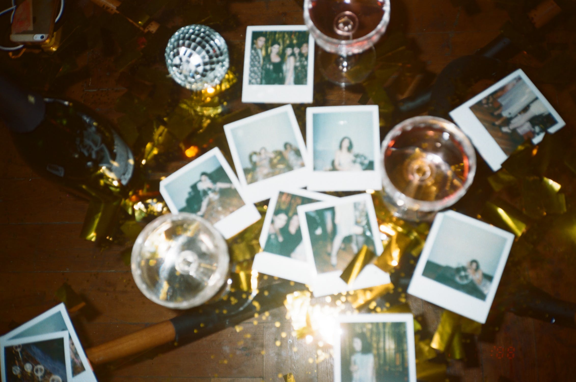 polaroid photos printed with champagne glasses on a tabletop