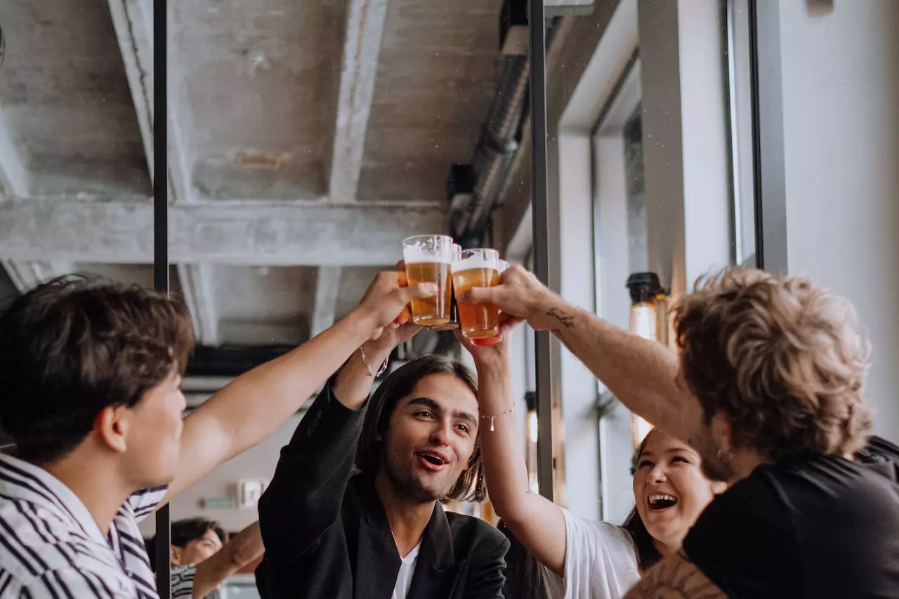 men cheers beer in a restaurant with happy faces