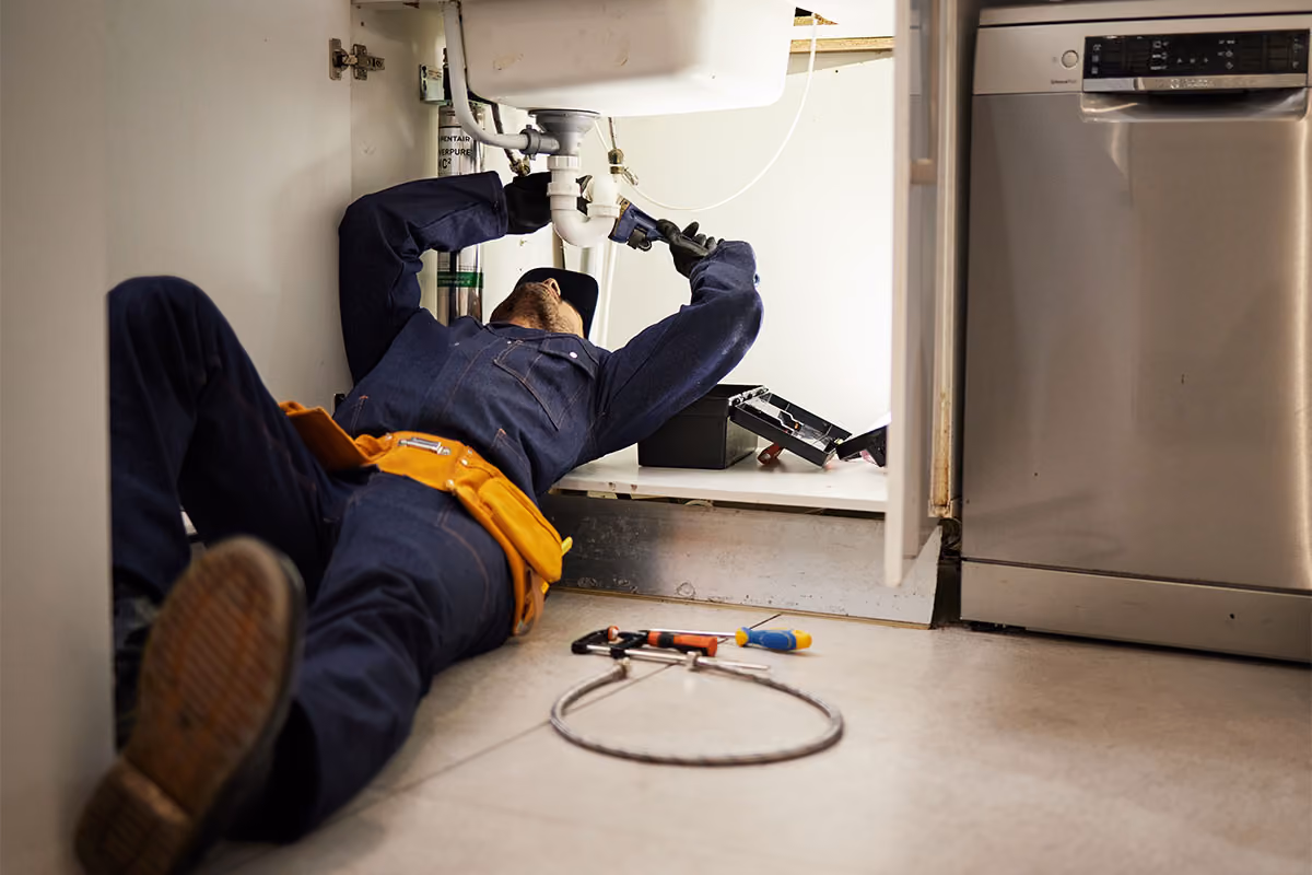 Emergency plumbing service fixing a leaking sink.