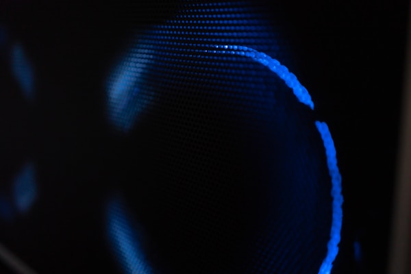 Blue light glows against a dark background.