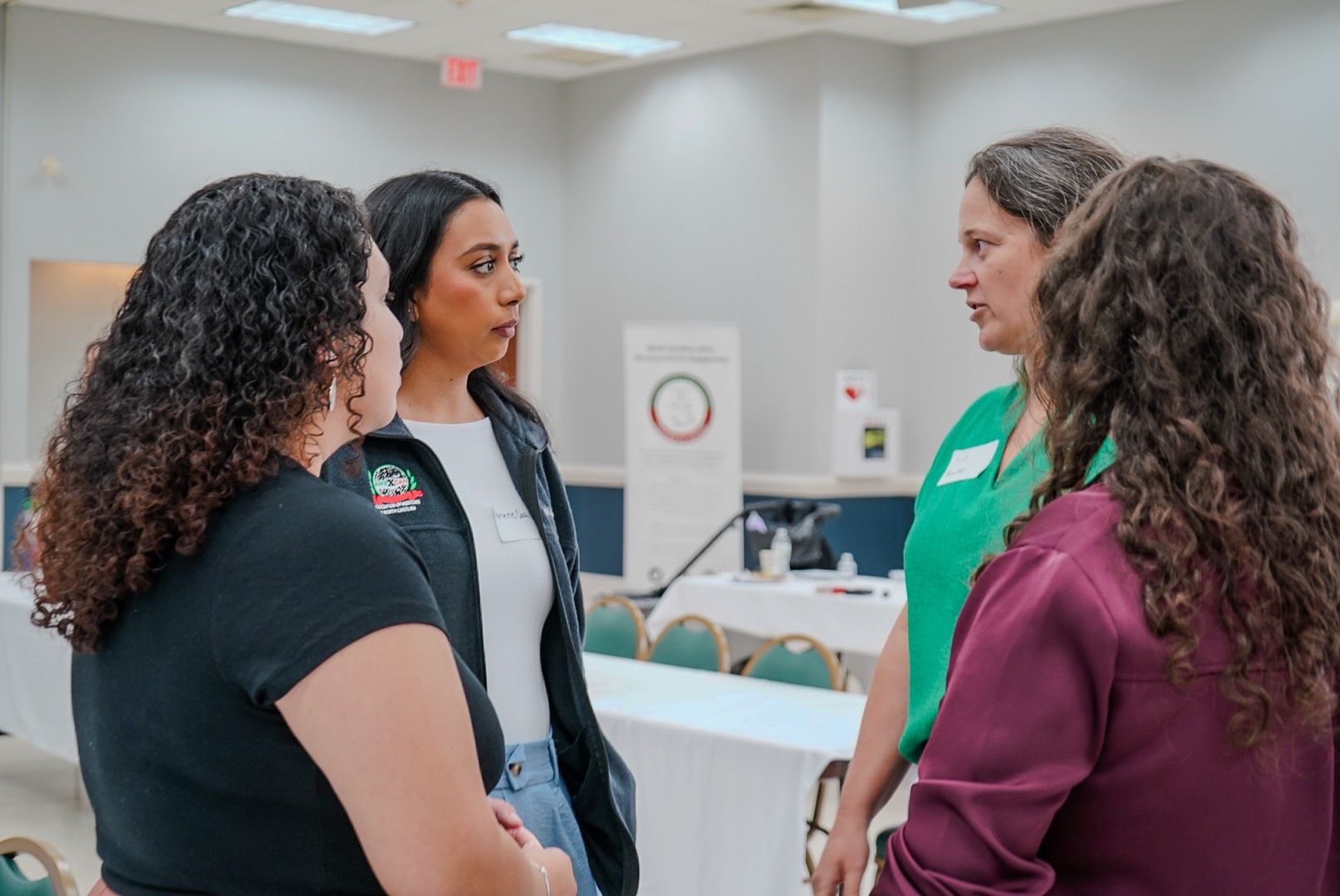 Protesters holding a sign that reads 'Due Process is a right of every person in our country' with a blurred American flag in the foreground.