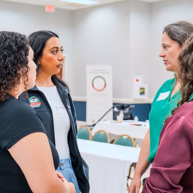 Protesters holding a sign that reads 'Due Process is a right of every person in our country' with a blurred American flag in the foreground.