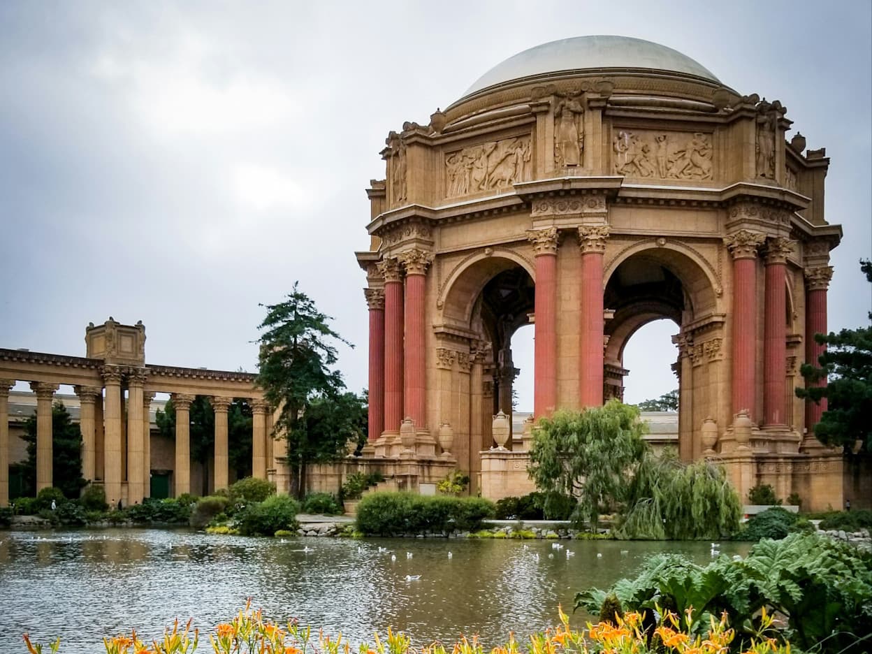 The Palace of Fine Arts focal point, an iconic landmark in the city. Painted a red-terracotta color, the structure pops among the green surroundings and the pond on which it is perched. Located in the Marina District of San Francisco.