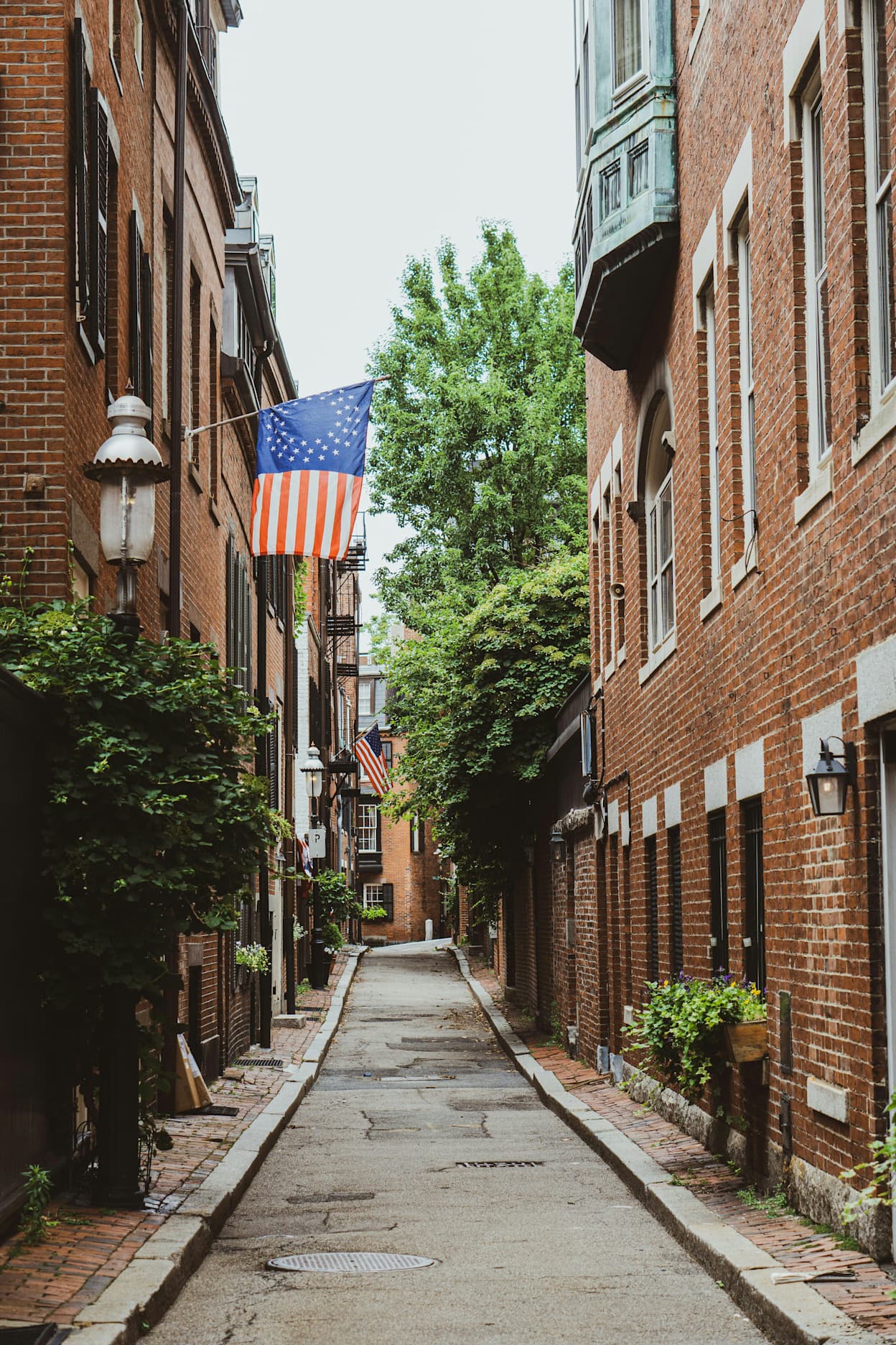 The famous Acorn Street in Beacon Hill, Boston. This is the most photographed street in the world, lined with brownstone brick buildings and cobblestone sidewalks.