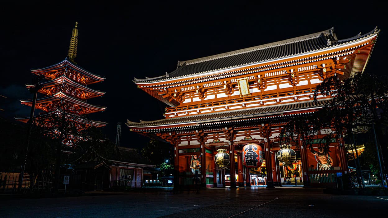 The Asakusa Shrine lit up at night featuring Japanese lanterns.