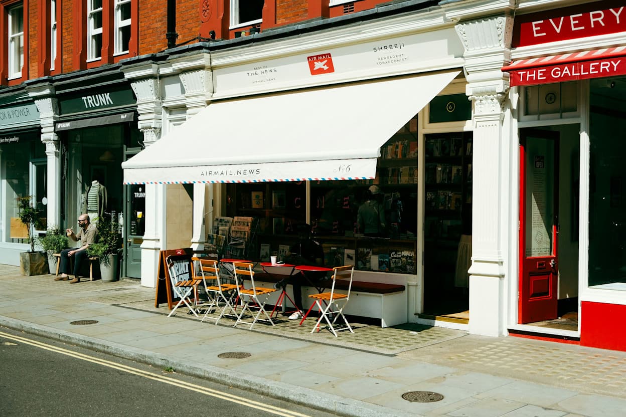 Street in Marylebone, London of white awning over a cafe with chairs outside