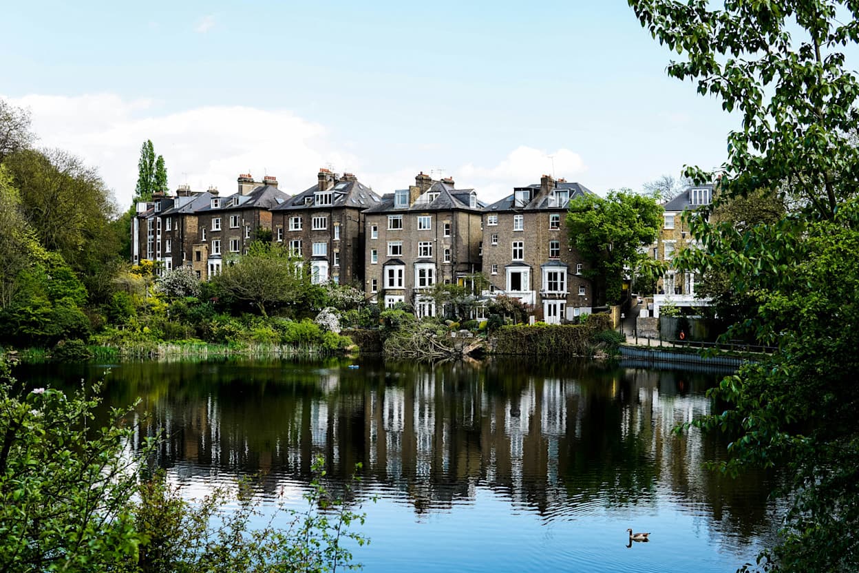 Houses along a canal lined with trees in Hampstead, London