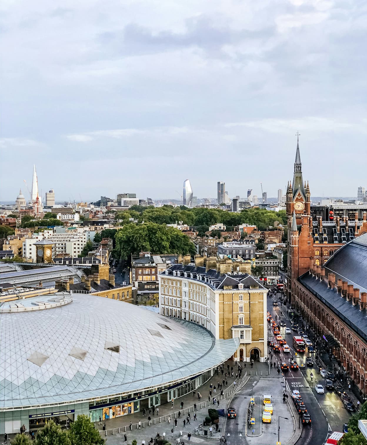 Birds-eye view of a carousel in King's Cross, London with the full London skyline in the background