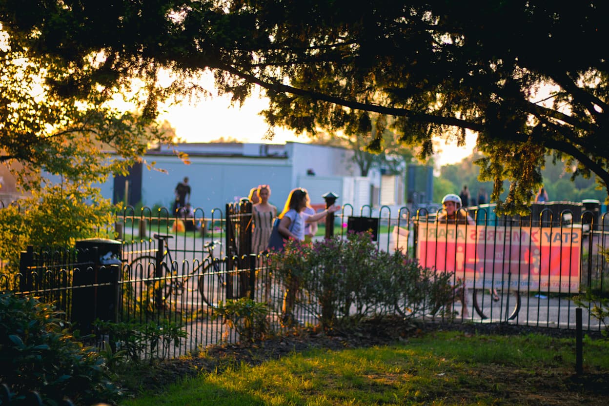 People talking at a park in Peckham, London.