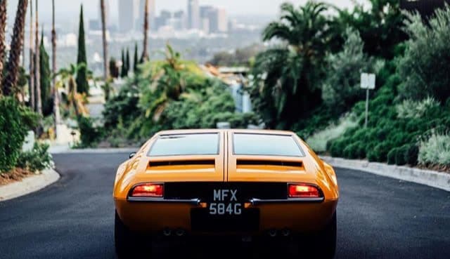 Vintage orange car on a street overlooking LA