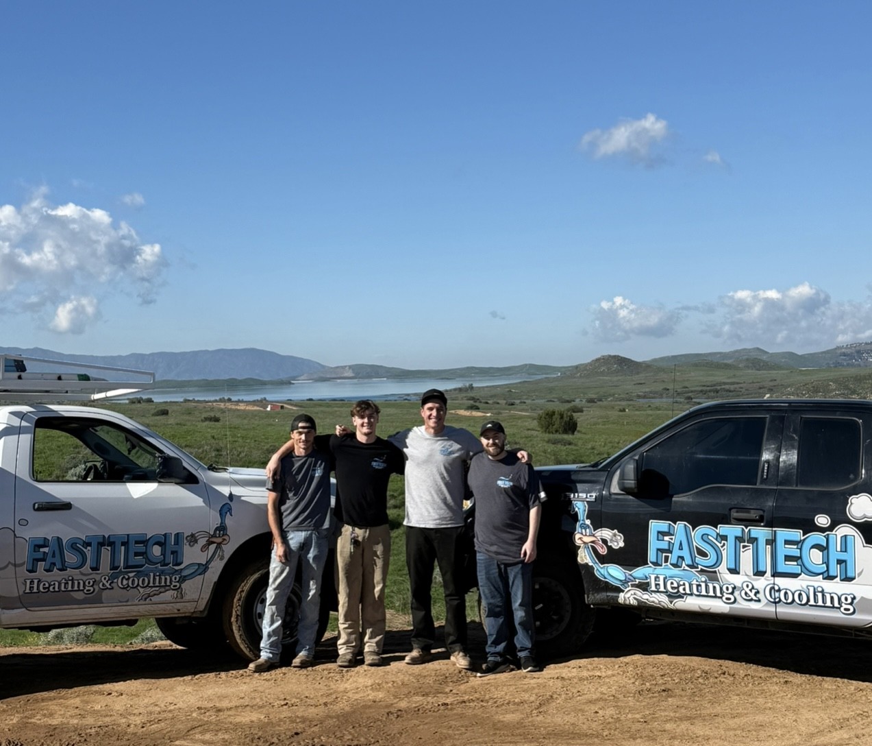 Fast Tech Heating & Cooling HVAC technicians standing together in front of service trucks, proudly serving Riverside County, CA.
