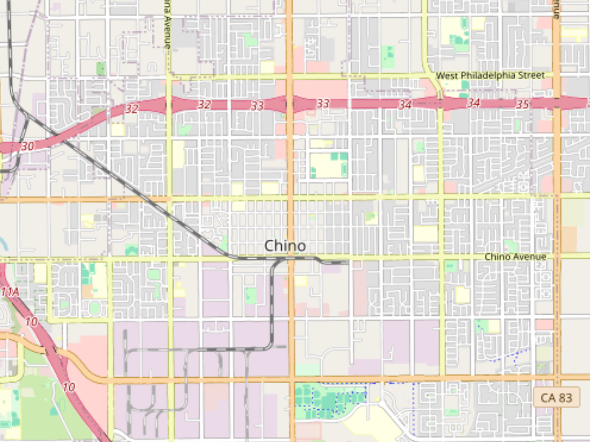 Map showing the Chino Hills area with streets including Grand Avenue and Village Center Drive, surrounded by green parkland and residential neighborhoods.