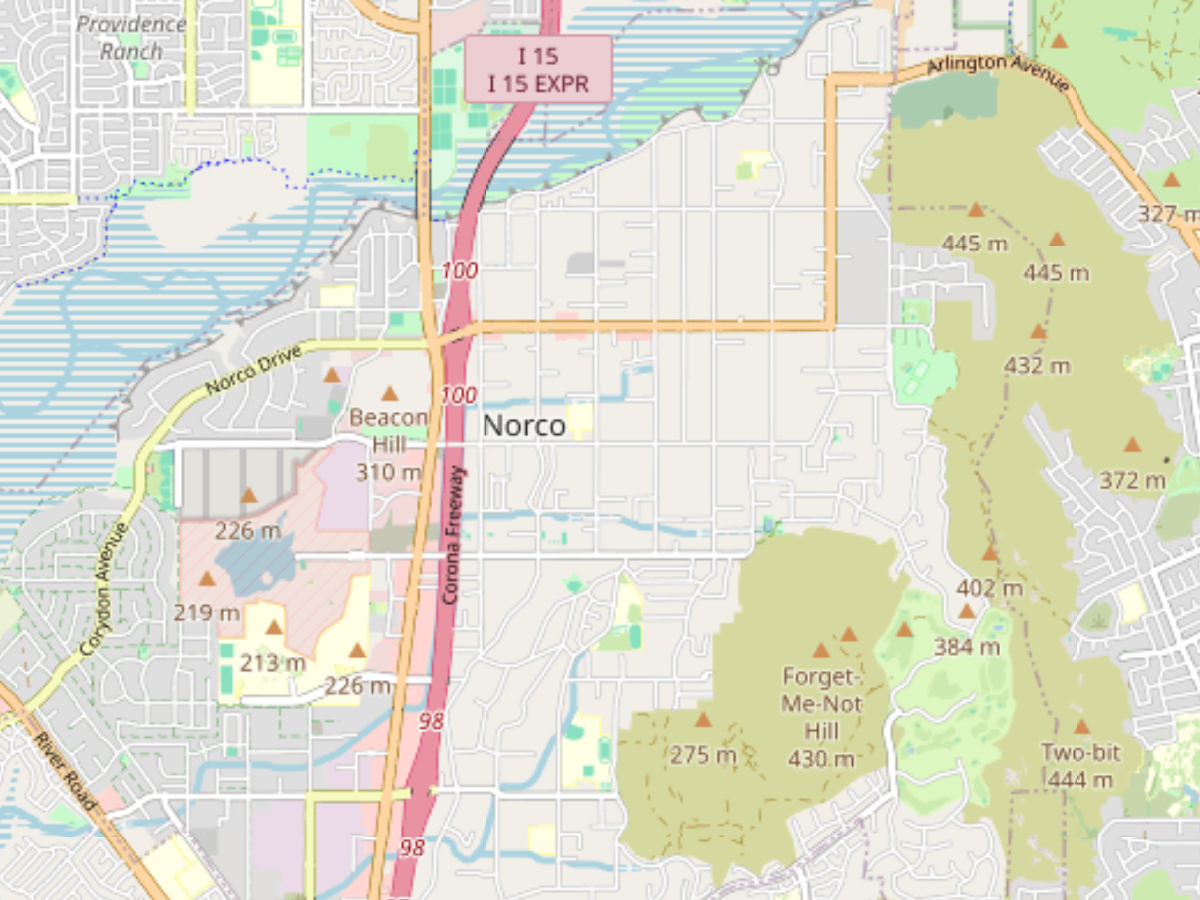 Map showing Norco area with Corona Freeway (I-15) running north-south, surrounding streets, and elevation markers for nearby hills.