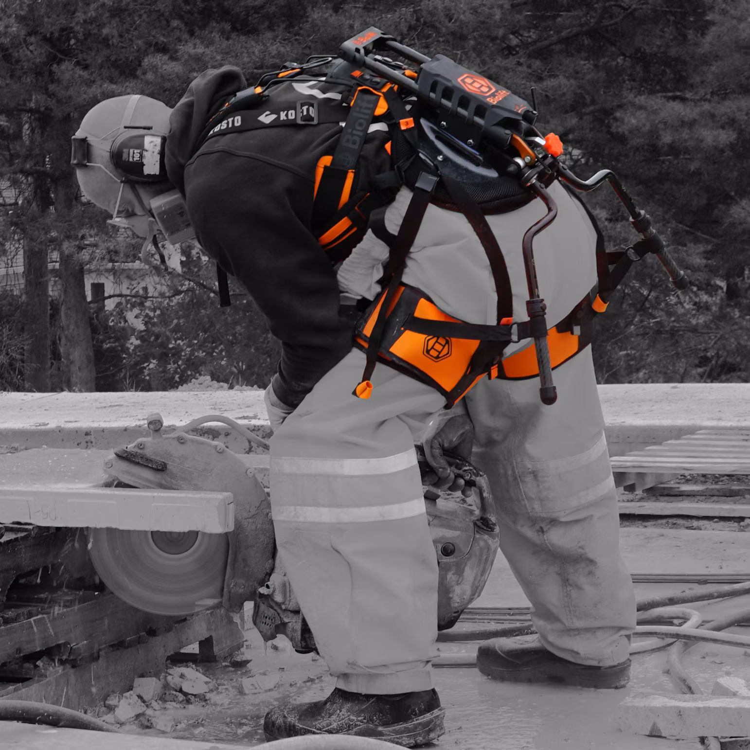 Close-up of a worker running a cut-off saw with the Biolift Carbon exoskeleton