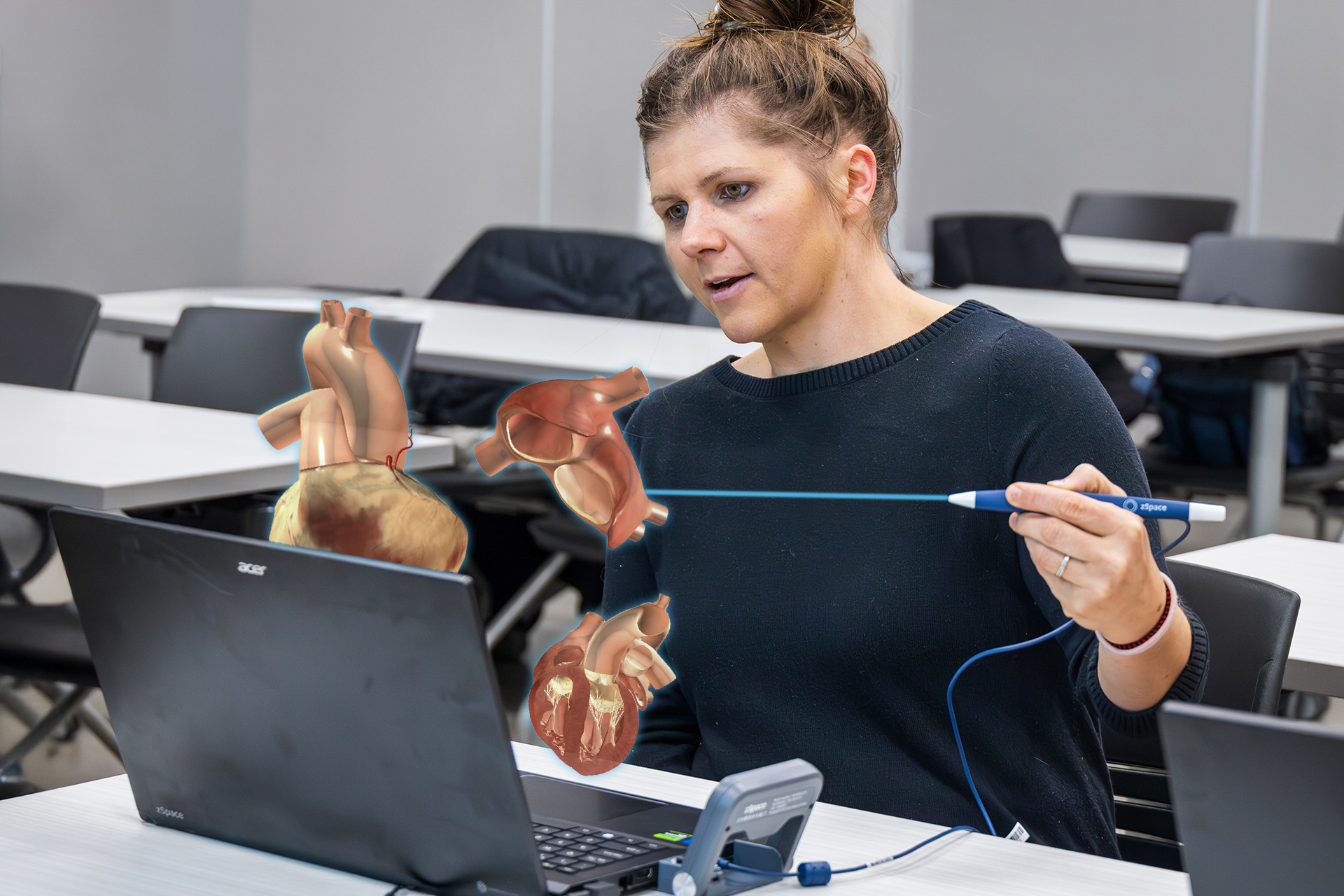 woman using a stylus to handle a digital organ that see sees on her 3D laptop