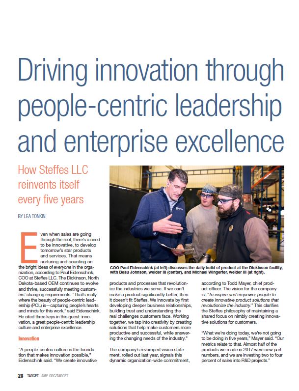 Article titled 'Driving innovation through people-centric leadership and enterprise excellence' featuring a photo of three men in a manufacturing facility discussing a product, with one man holding a tablet.