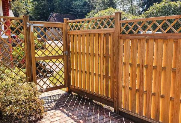Green Leaves Fencing & Gates van beside newly installed timber fencing and bespoke garden gate with trellis in East Grinstead