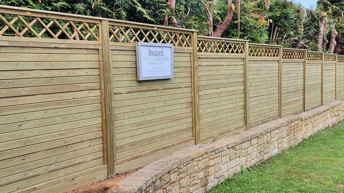 Closeboard timber fence installation with decorative garden plants in East Grinstead.