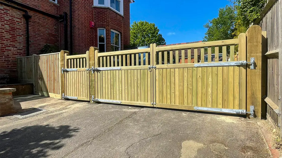 Closeboard timber fence installation with decorative garden plants in East Grinstead.