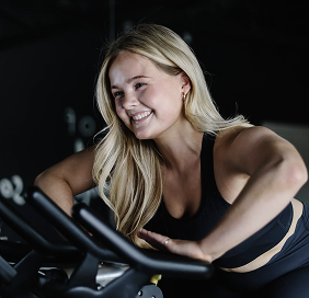 woman riding cycling machine smiling