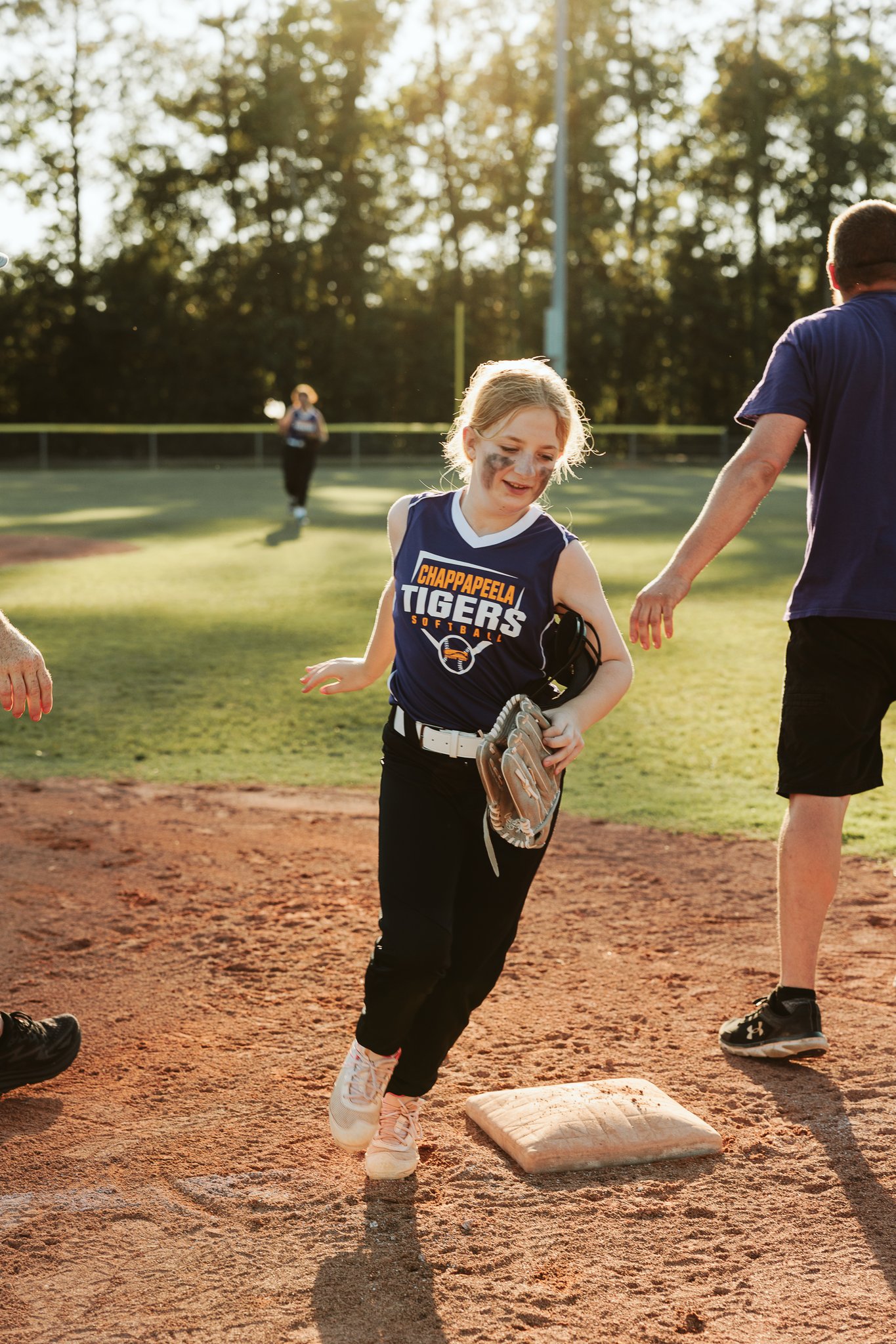 miling Chappapeela Tigers softball player with eye black running across a base during a youth game at CSP.
