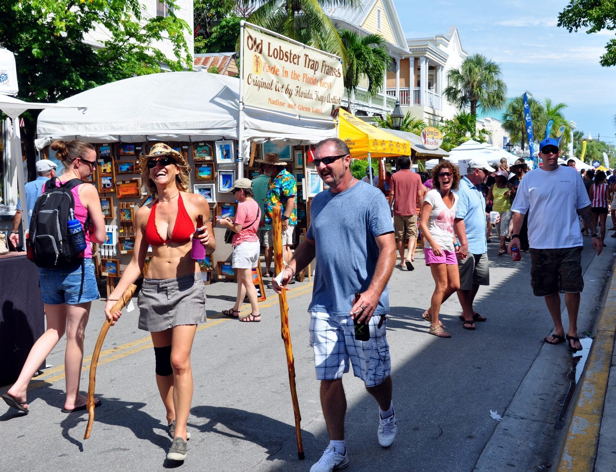 Older couple walking down Duval Street