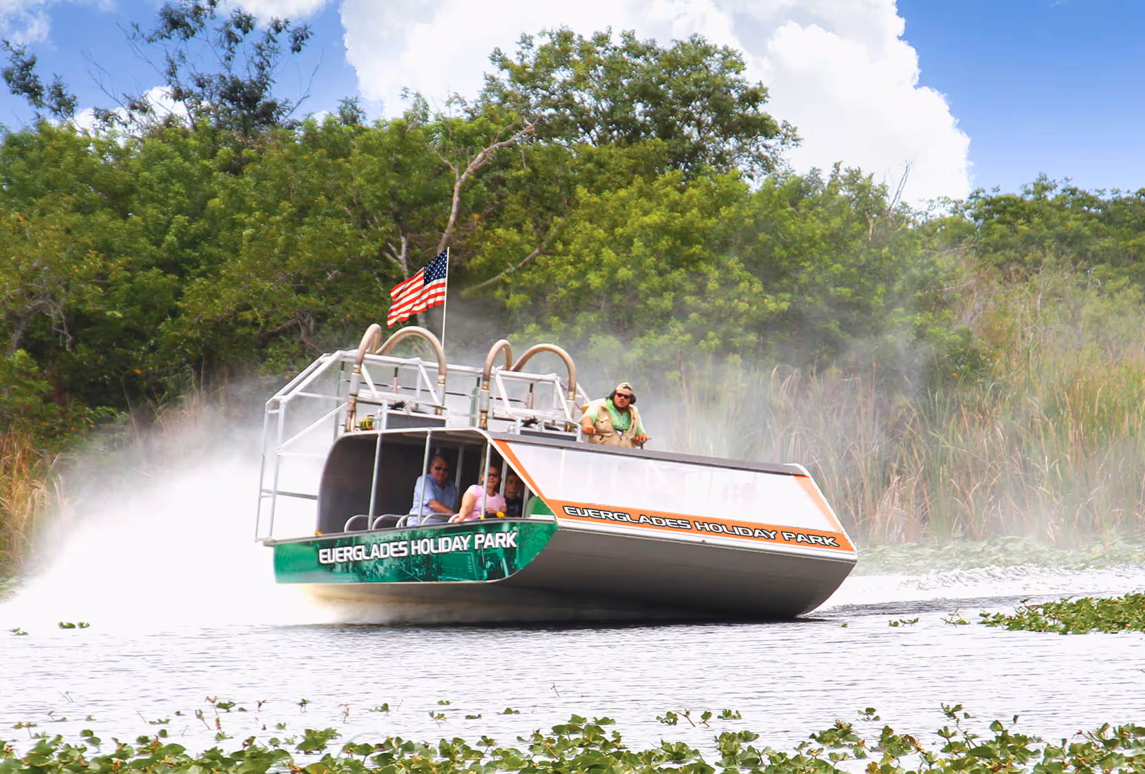 Green airboat making a tight turn on the water