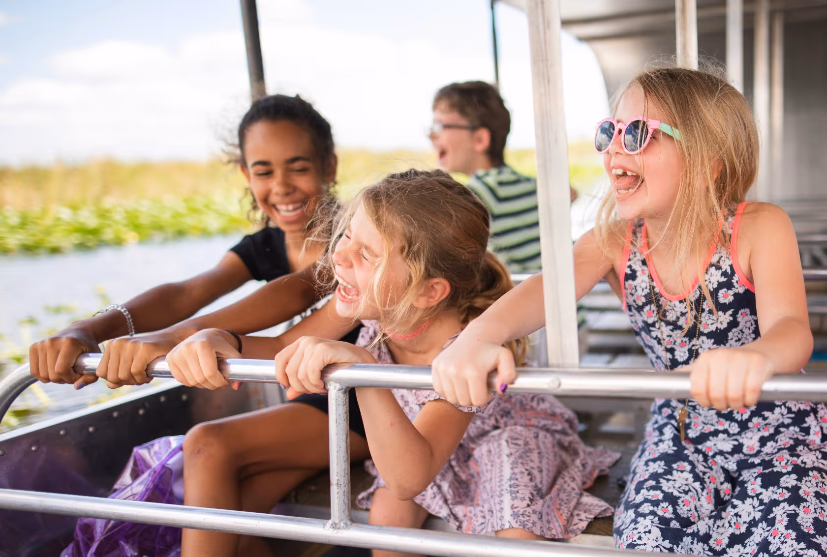 Three kids having fun on an swamp boat ride