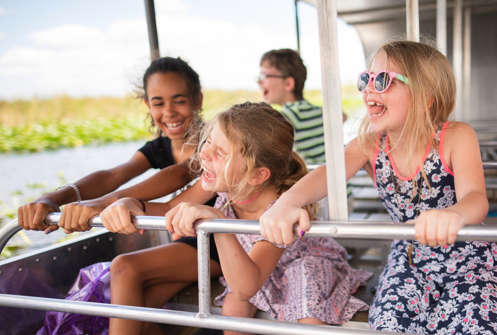 Three kids having fun on an swamp boat ride