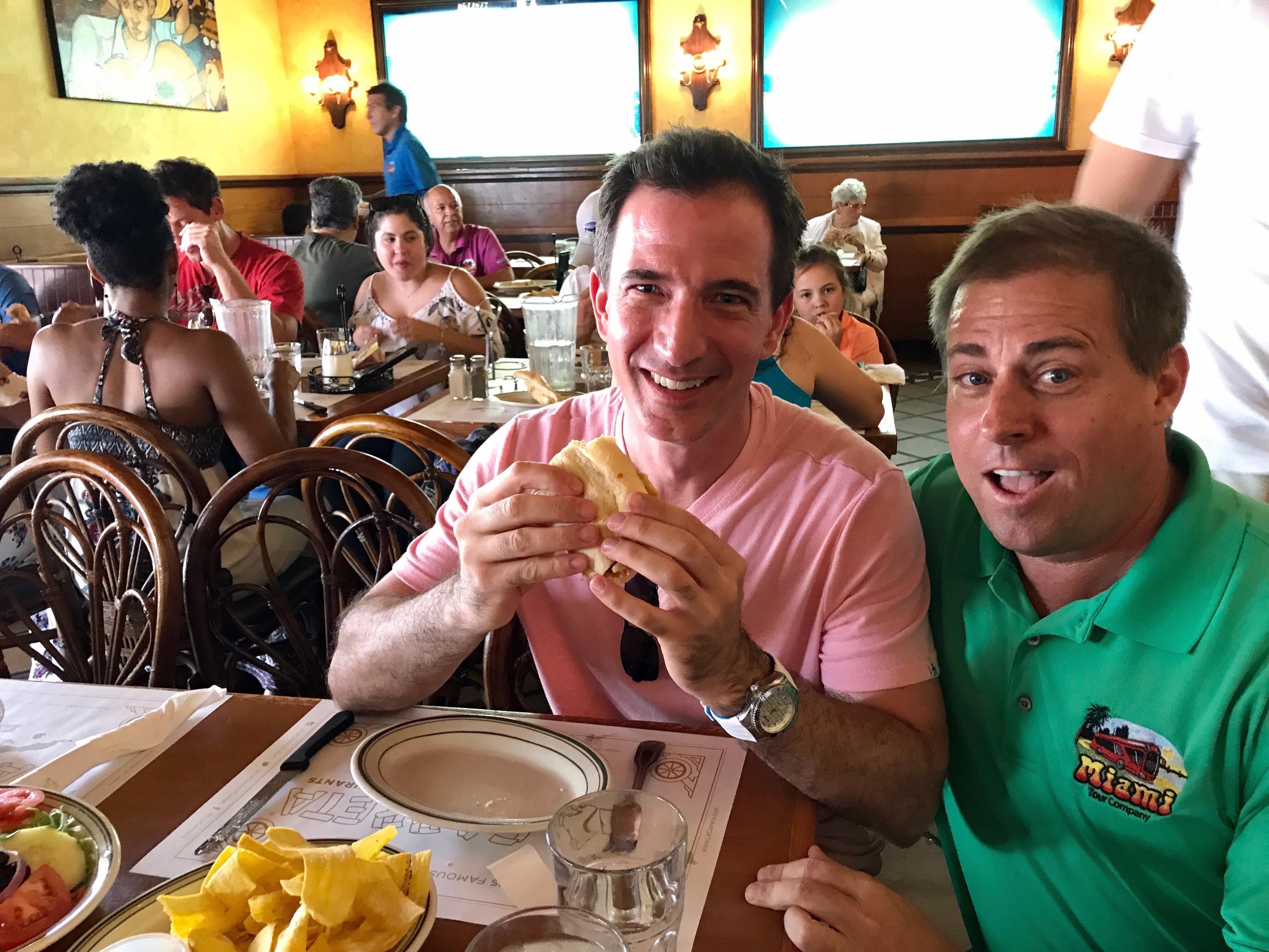 Tour group eating Cuban sandwich inside the restaurant