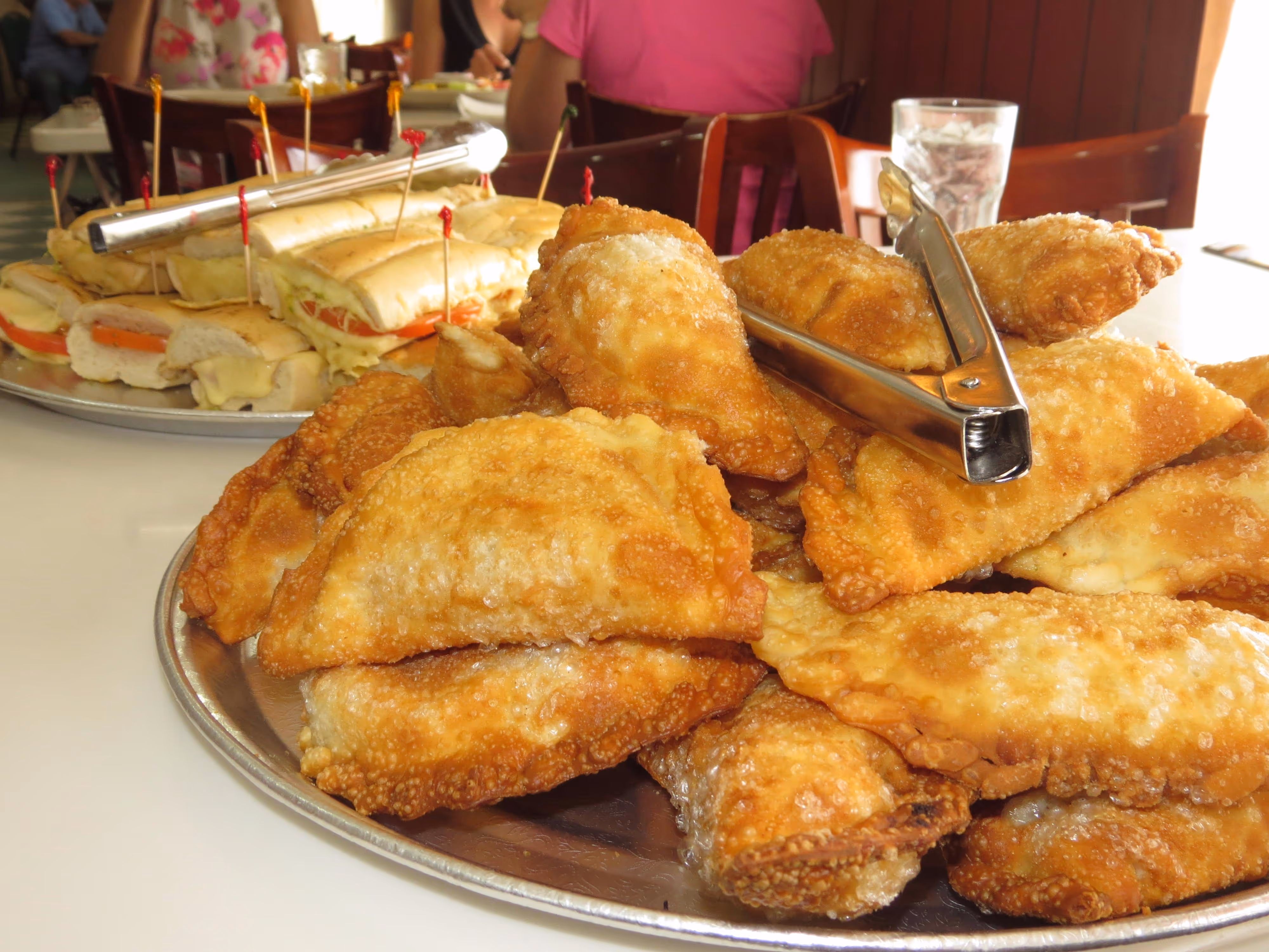 A platter of crispy chicken empanadas