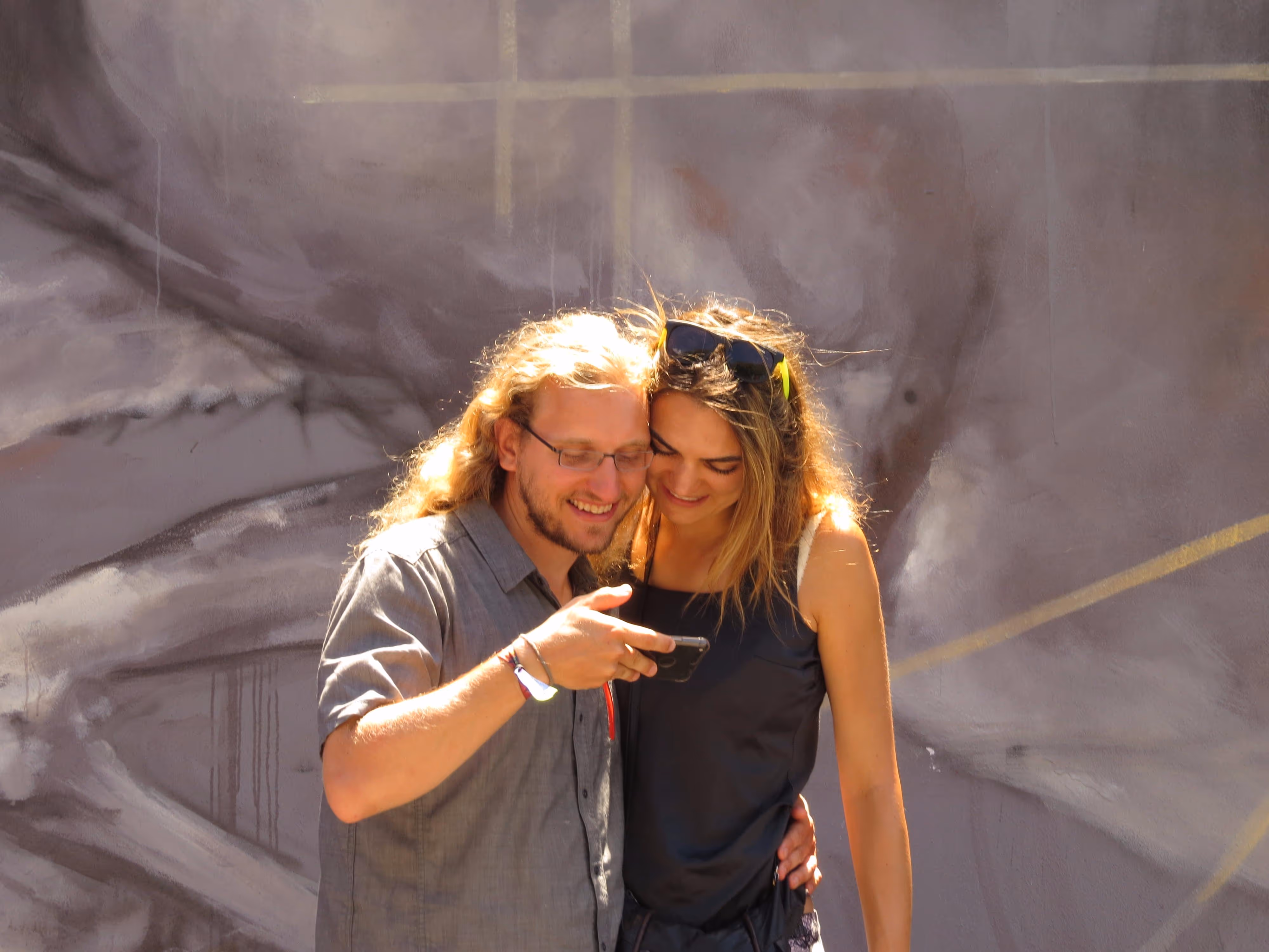 Young lovers admiring their vacation photos