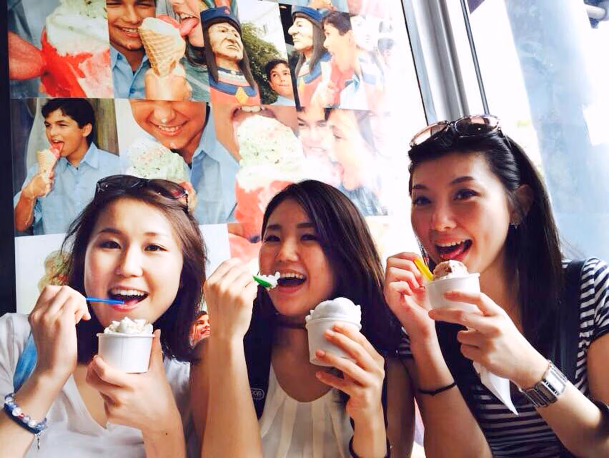 Smiling young Asian ladies enjoying ice cream