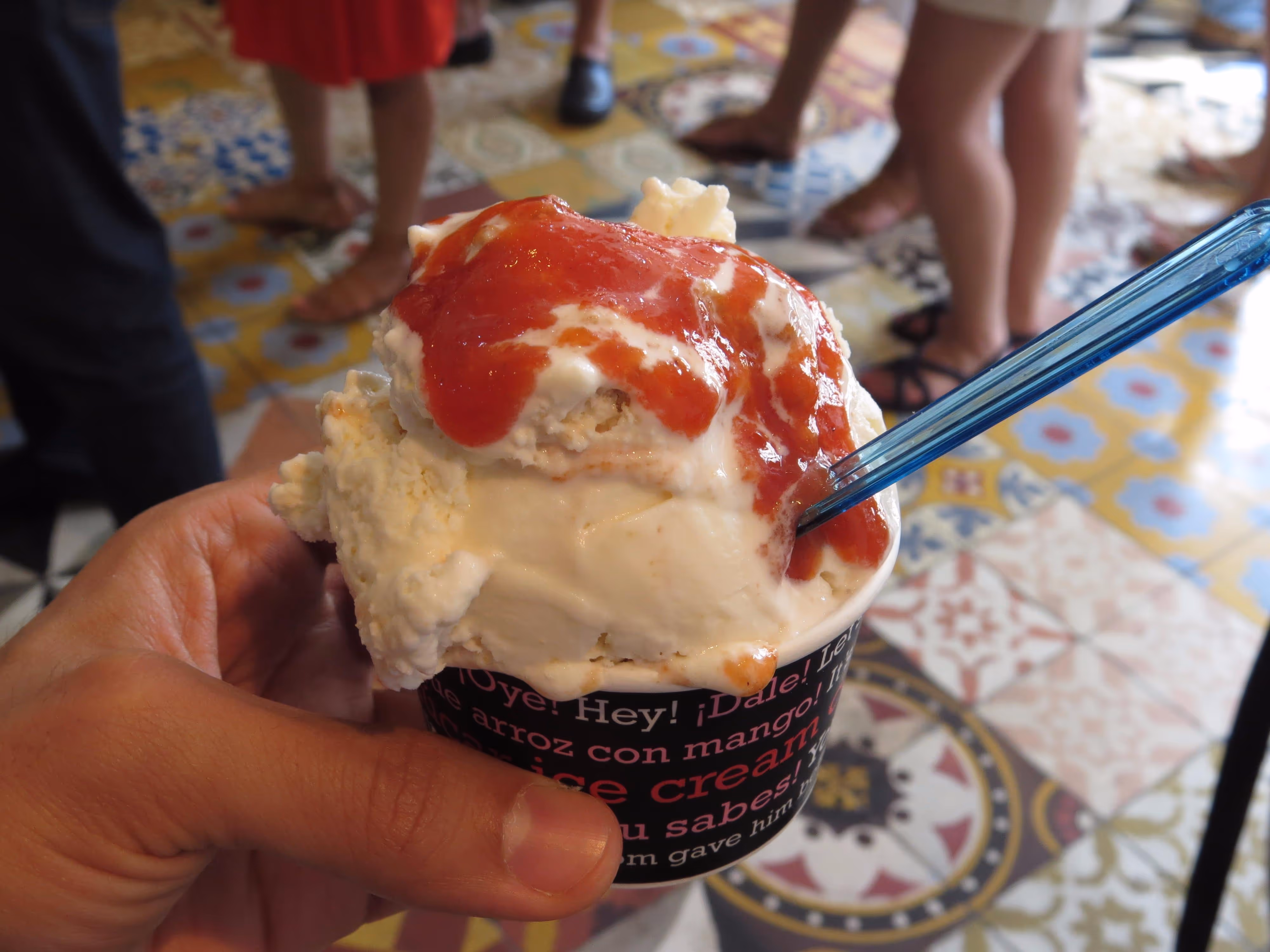 Close-up of a cup of guava ice cream overflowing with syrup
