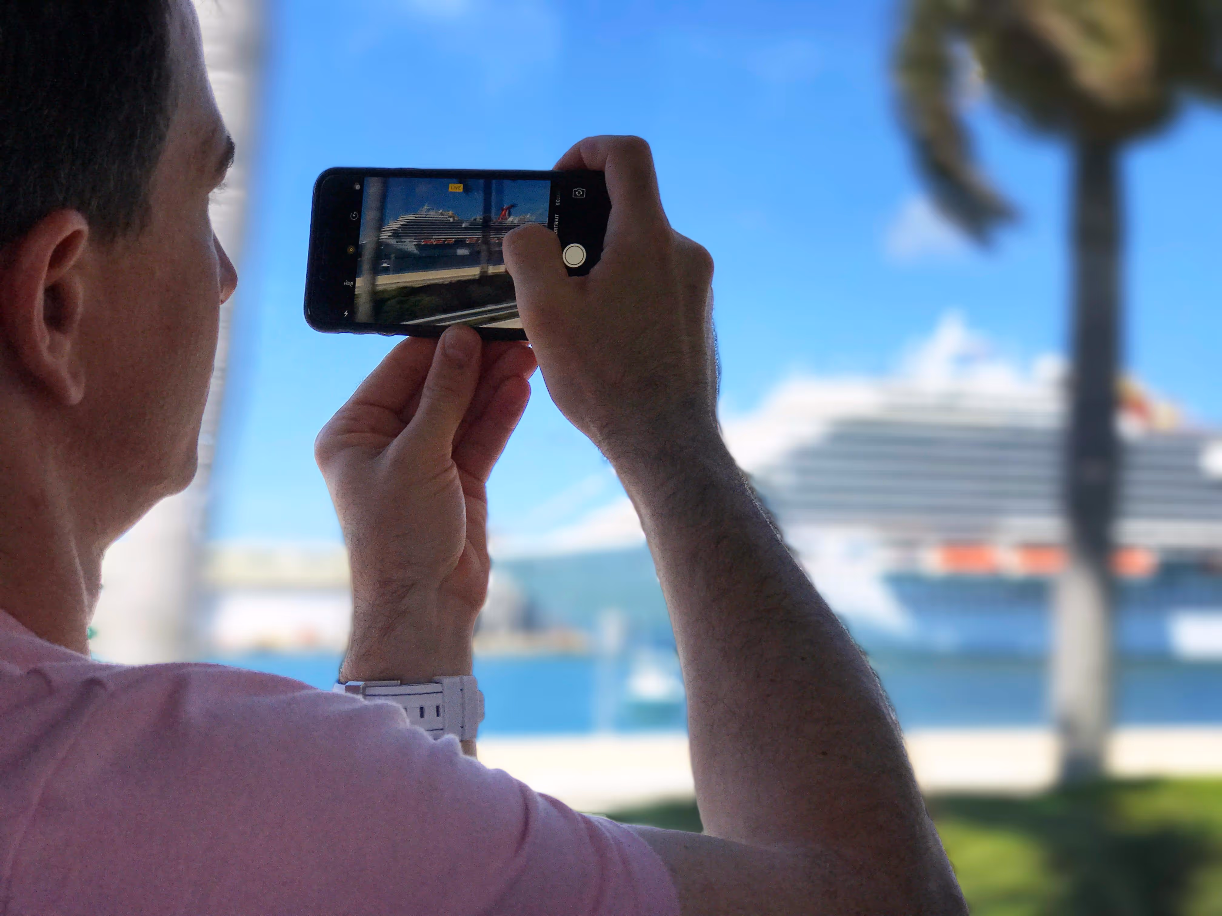 Taking a photo of a colorful cruise ship from inside the tour van