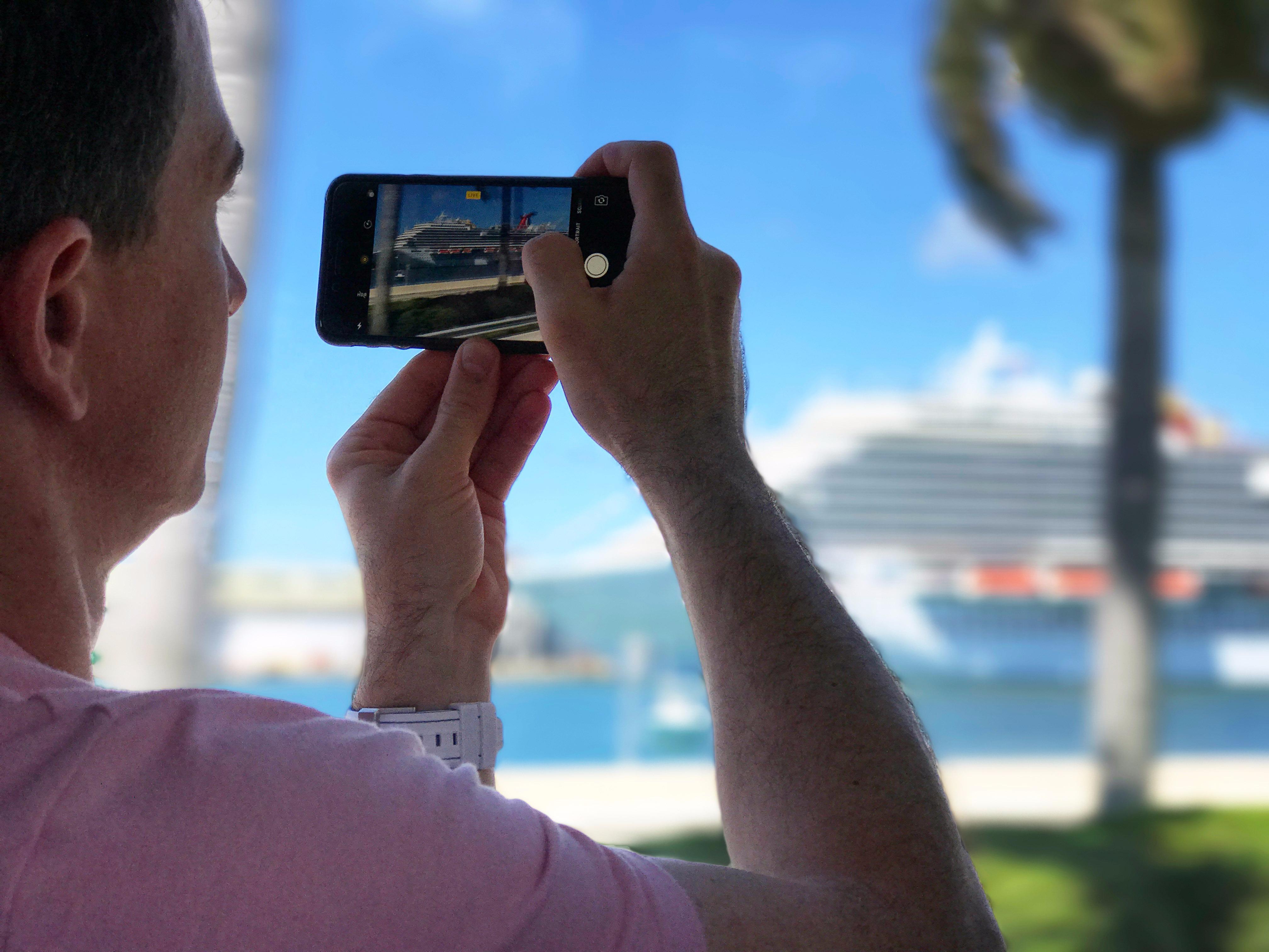 Taking a photo of a colorful cruise ship from inside the tour van