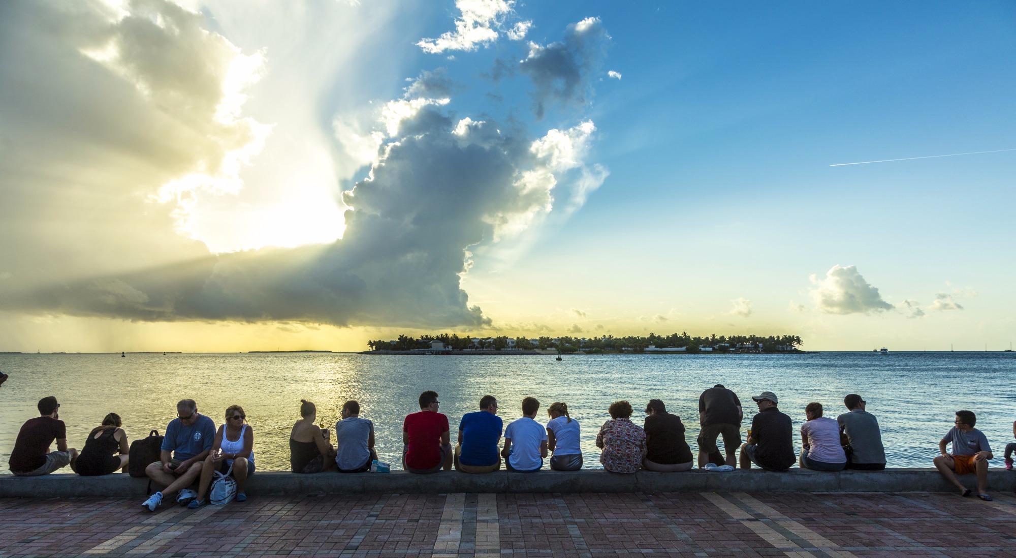 Friends enjoying the sunset over the water