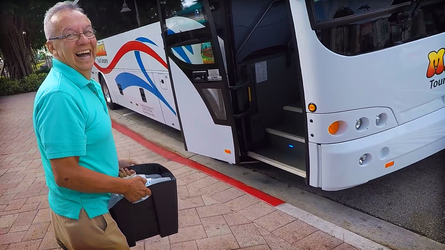 Smiling tour bus driver with free water for passengers