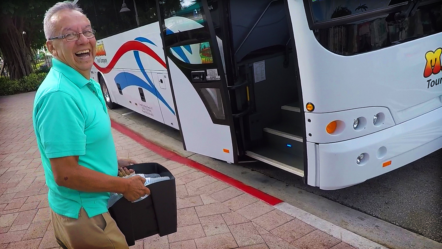 Smiling tour bus driver with free water for passengers