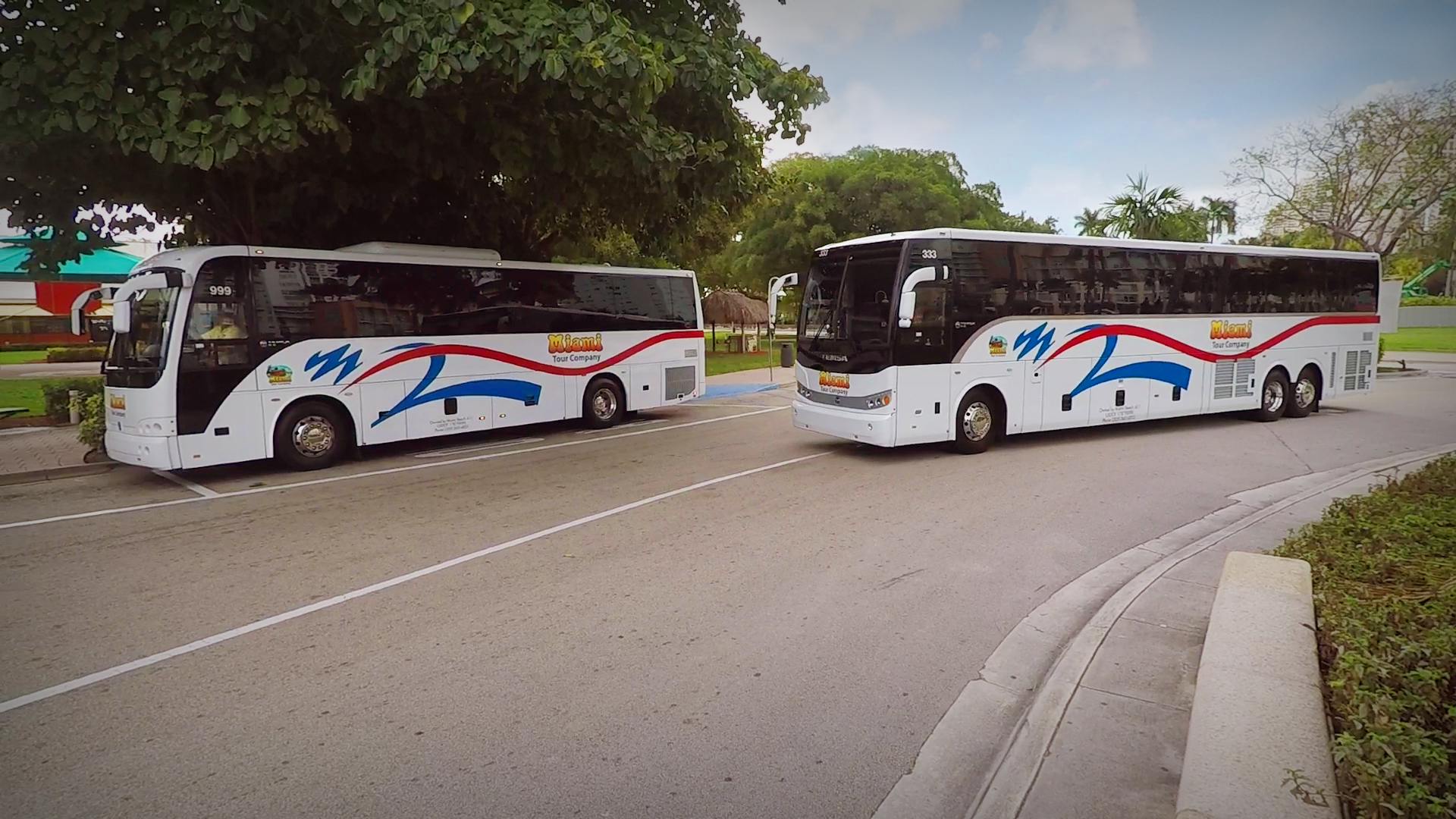 Two tour buses arriving at Bayside on a cloudy day