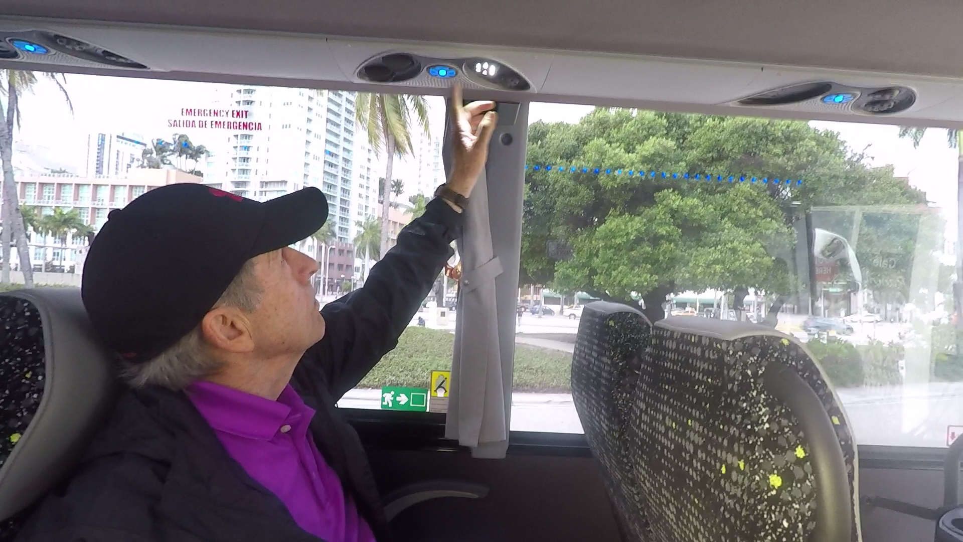 Tour bus driver showing how to operate passengers's air conditioning 