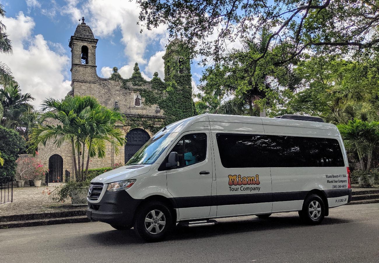 Private tour van parked near historic church in Coconut Grove